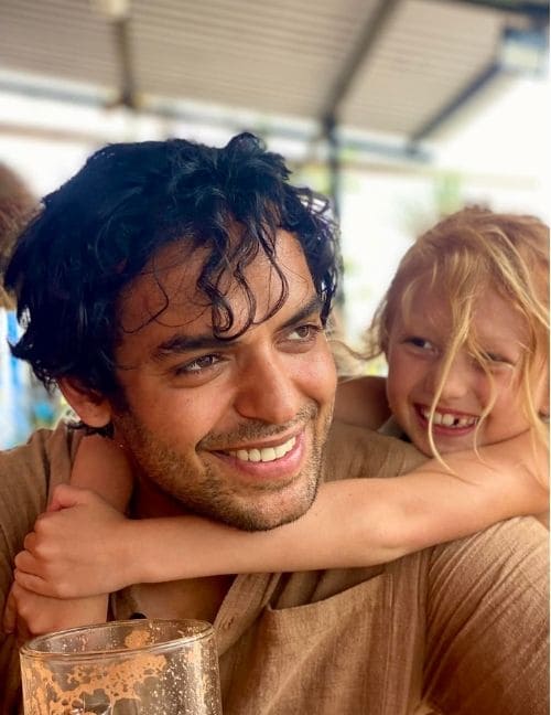 Hans smiling with Joyaa leaning on his shoulder