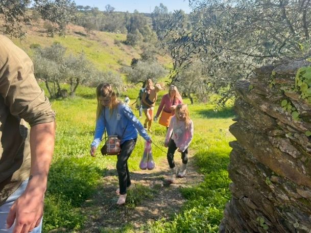 Calm natural swimming pool with crystal clear water reflecting the blue sky, surrounded by natural rocks