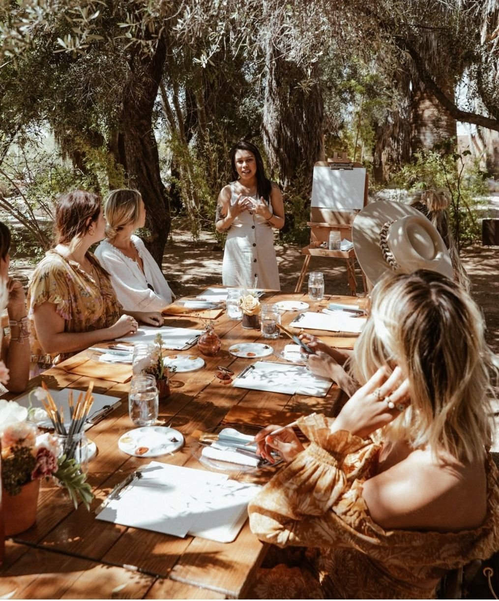 Sunlit pottery studio with rustic wooden tables, earthenware pots, and soft dust motes dancing in golden morning light