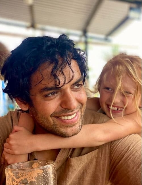 Hans smiling with Joyaa leaning on his shoulder